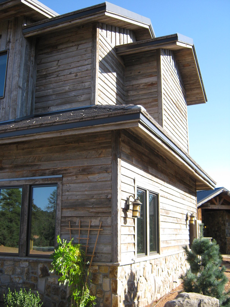 Photo of an expansive and beige rustic two floor house exterior in Phoenix with mixed cladding and a pitched roof.