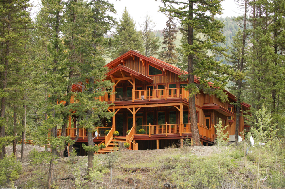 Aménagement d'une grande façade de maison marron montagne en bois à deux étages et plus avec un toit à deux pans.