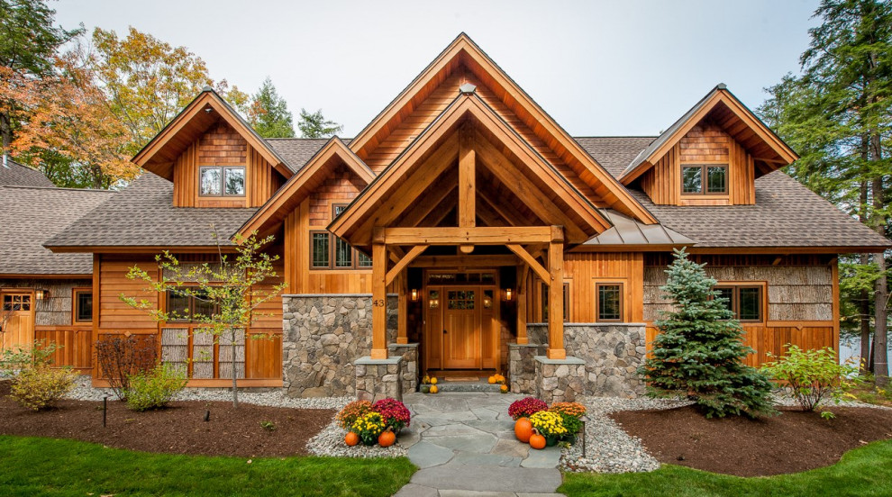 Example of a mid-sized mountain style brown two-story wood exterior home design in Manchester with a shingle roof