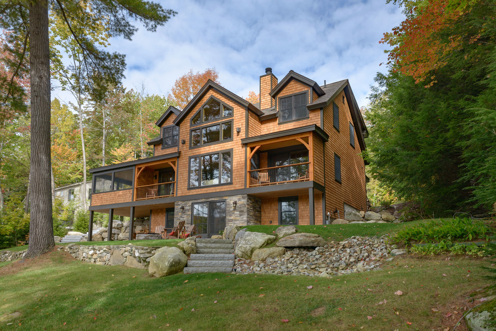 Example of a large mountain style brown two-story wood exterior home design in Boston with a shingle roof