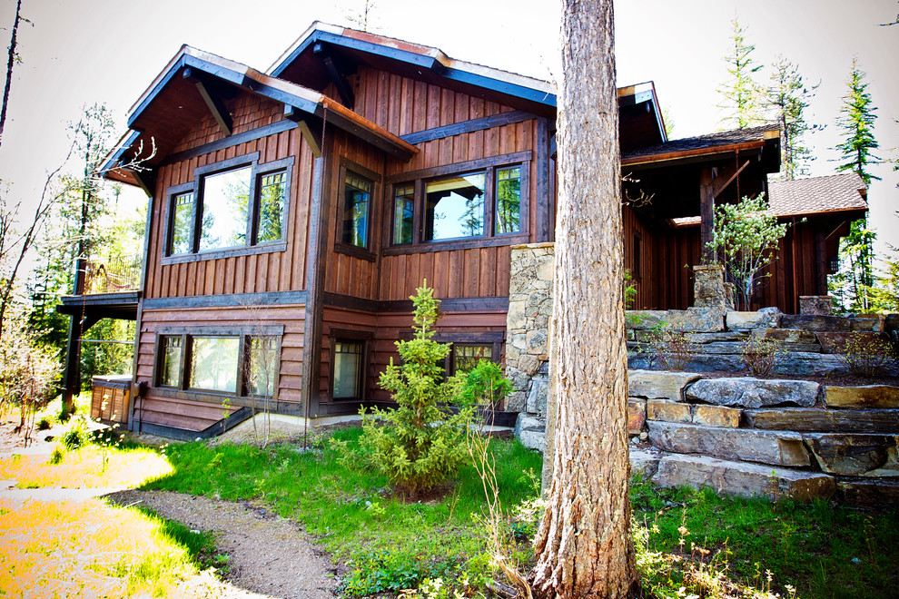 Photo of a brown rustic house exterior in Other with wood cladding.