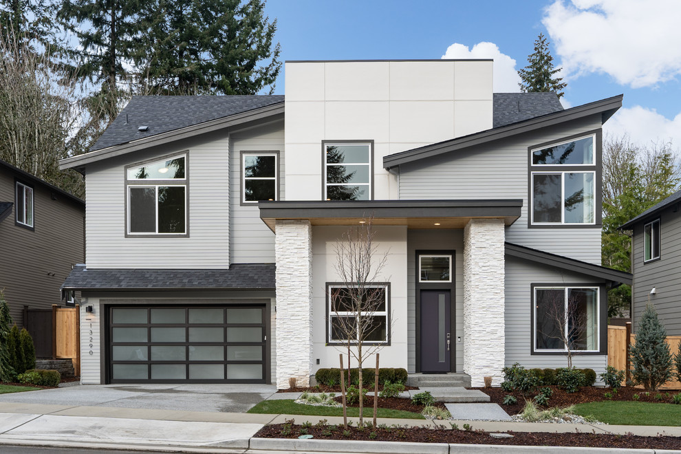 Inspiration for a contemporary white two-story house exterior remodel in Seattle with a shingle roof