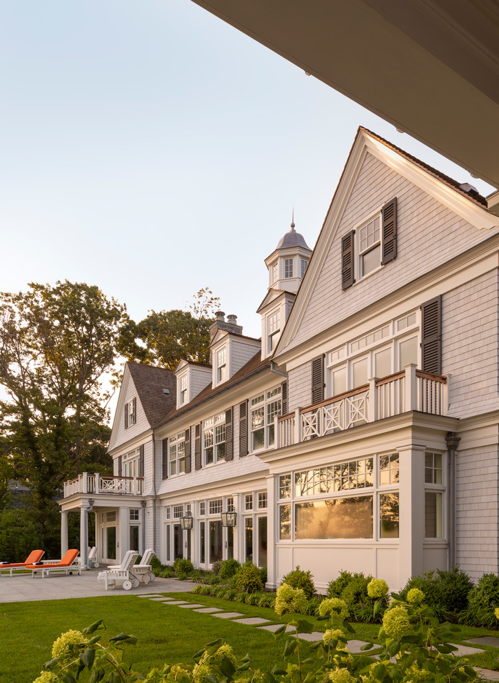 Inspiration for a huge coastal white three-story wood house exterior remodel in New York with a shingle roof