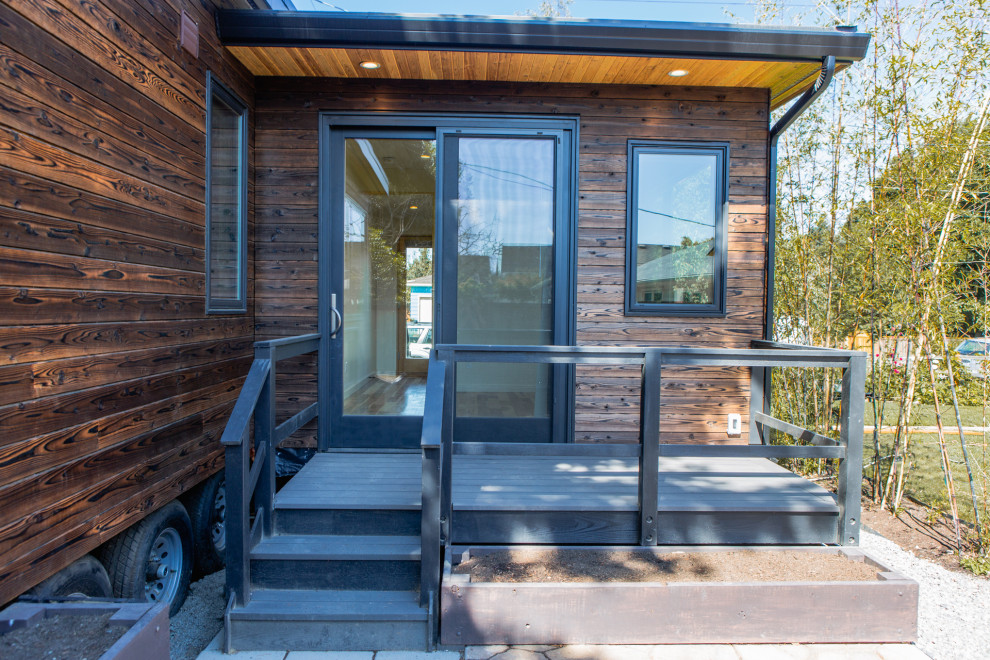 Inspiration for a small modern brown one-story wood exterior home remodel in Portland with a metal roof