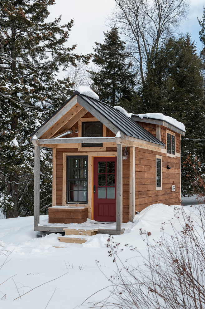 Example of a small mountain style two-story wood exterior home design in Burlington