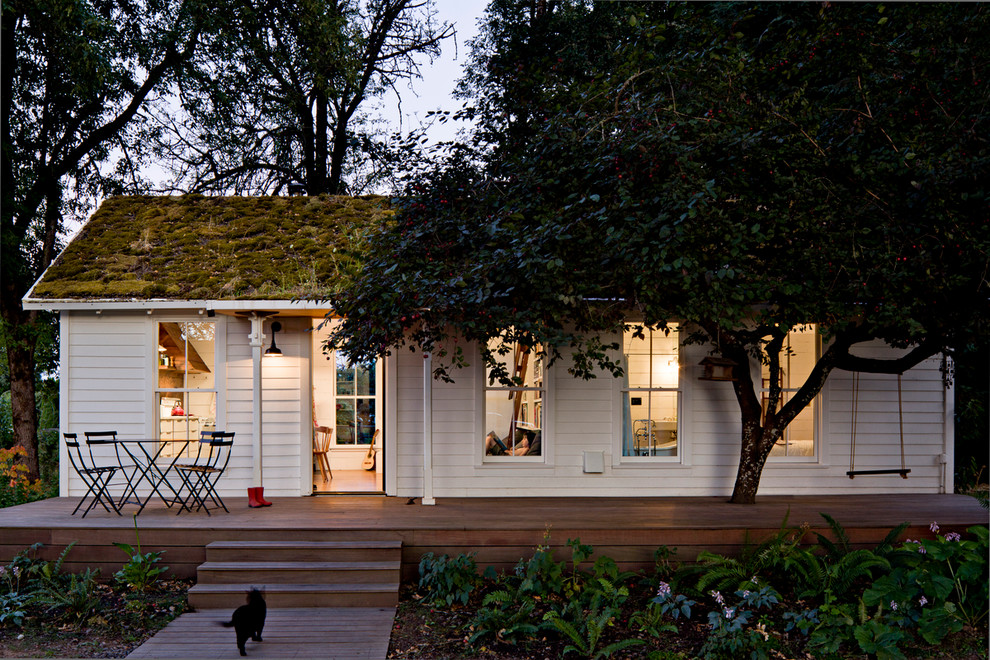 Inspiration for a small cottage white one-story wood exterior home remodel in Portland with a green roof