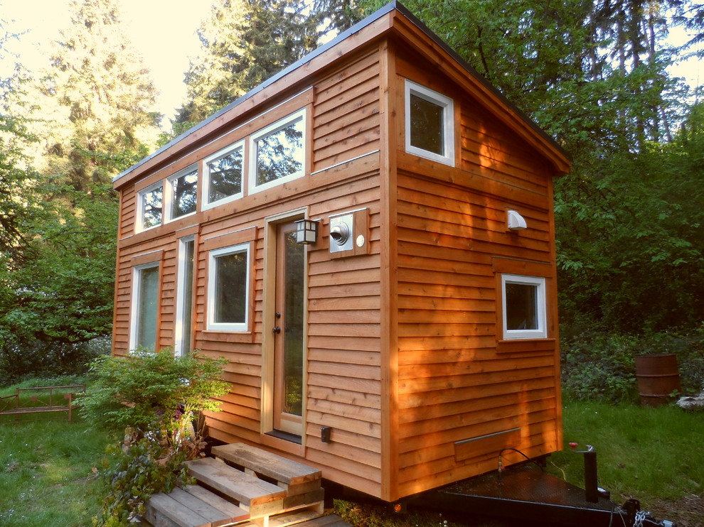 Inspiration for a small zen brown one-story wood exterior home remodel in Portland with a shed roof