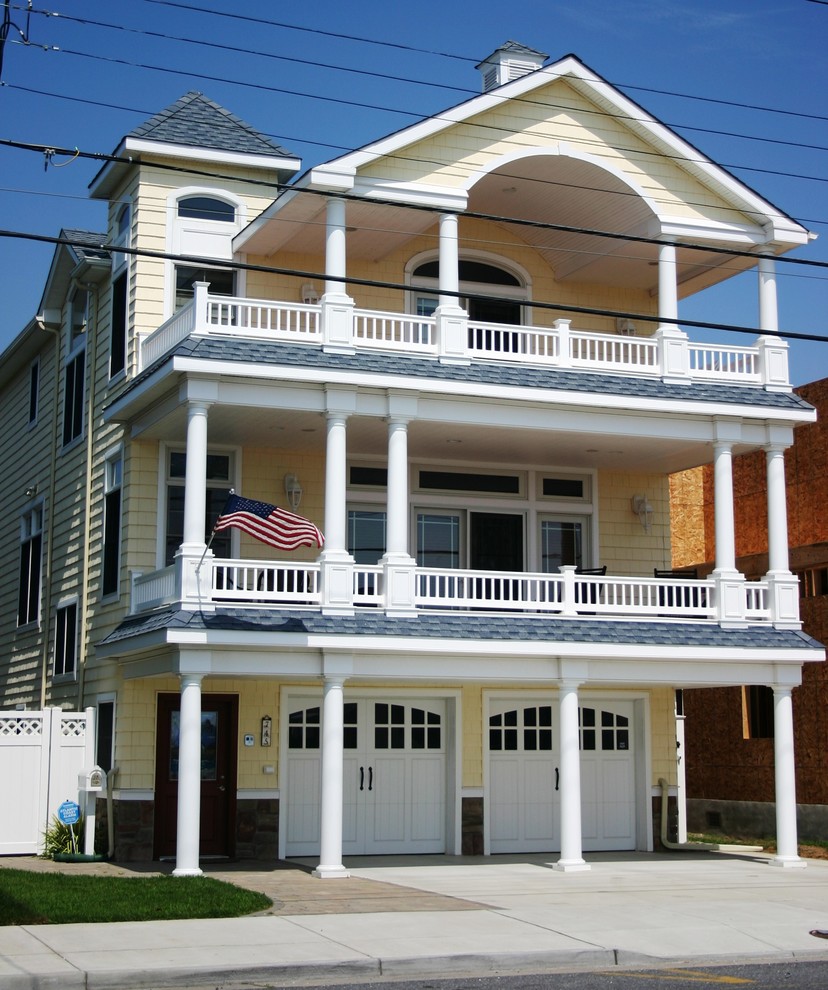 Large beach style yellow three-story mixed siding exterior home photo in Philadelphia