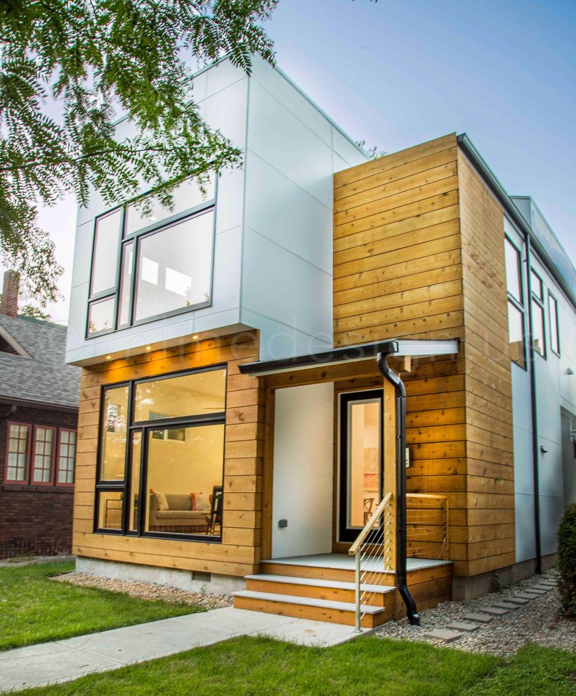 This is an example of a medium sized and white contemporary two floor detached house in Seattle with wood cladding, a hip roof and a mixed material roof.