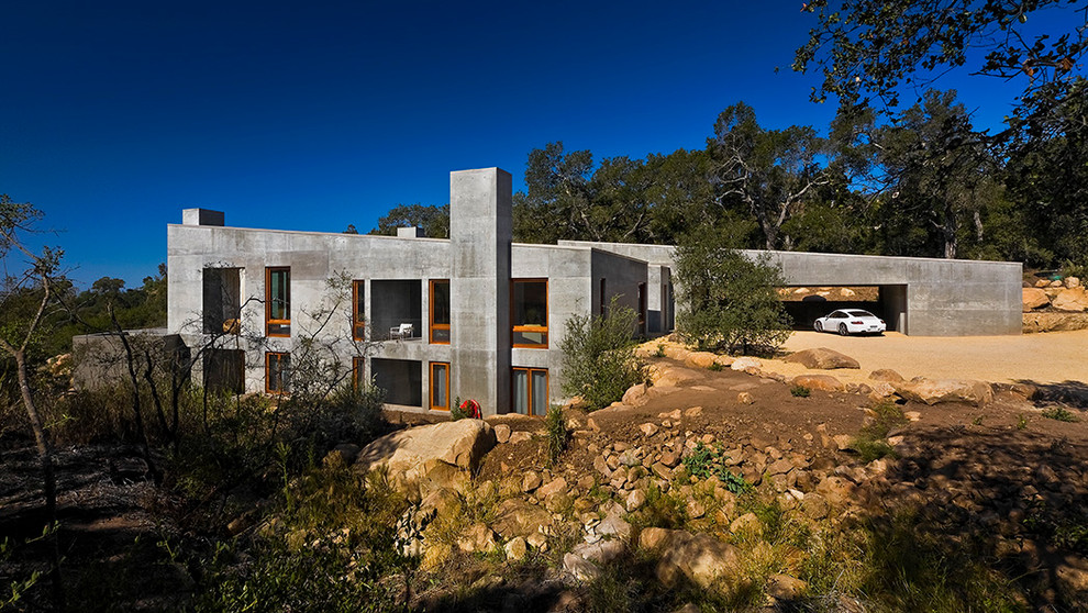 Photo of a gey rustic two floor concrete house exterior in Santa Barbara.