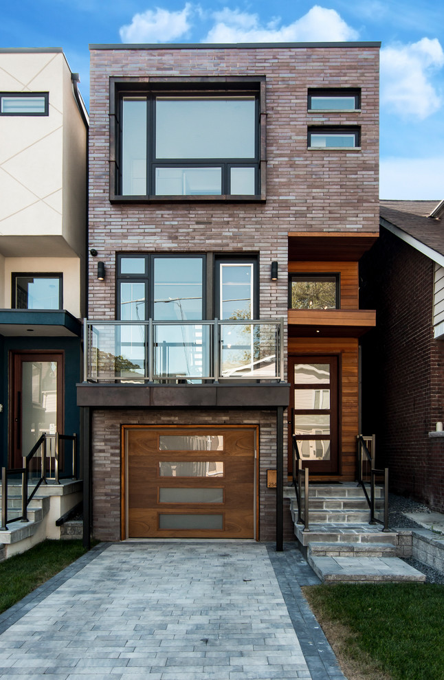 Medium sized and brown contemporary brick terraced house in Toronto with three floors and a flat roof.