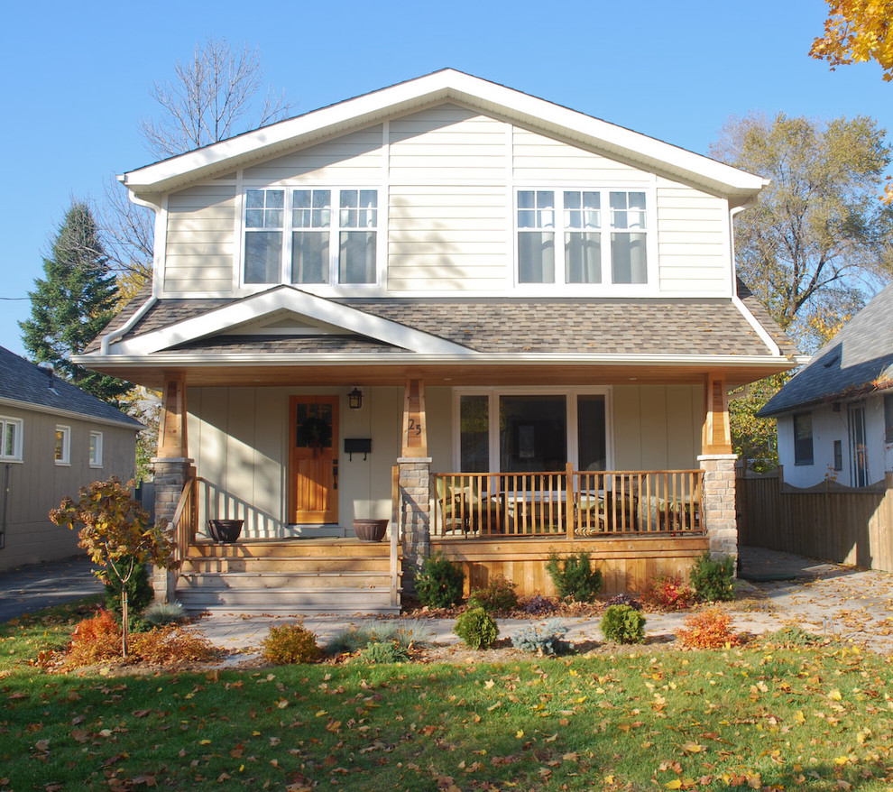 Example of a large classic beige two-story wood gable roof design in Toronto
