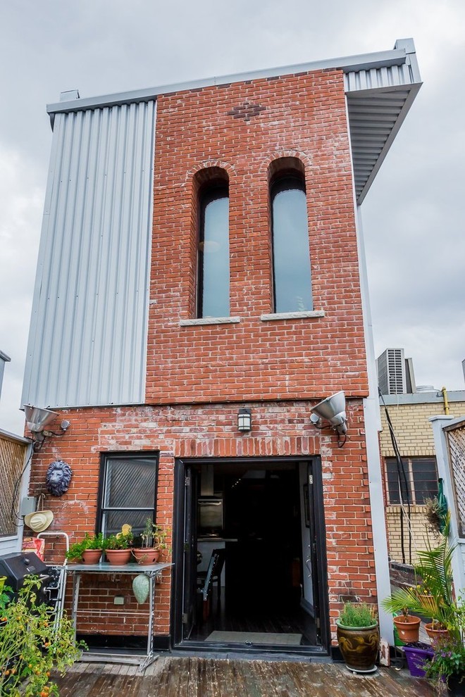 Zweistöckiges Industrial Haus mit Backsteinfassade und Flachdach in Toronto
