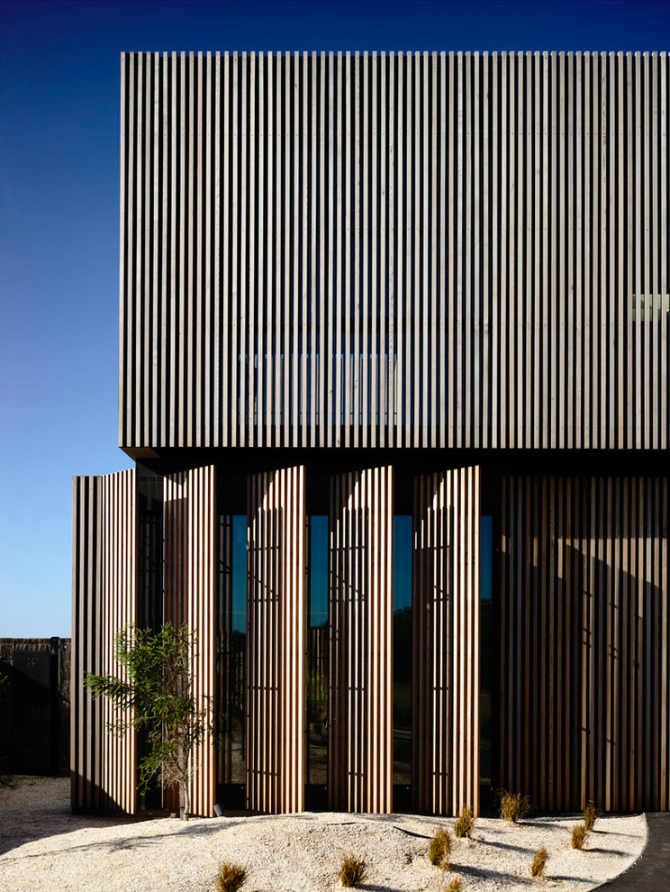 Imagen de fachada gris contemporánea grande de dos plantas con revestimiento de hormigón y tejado plano