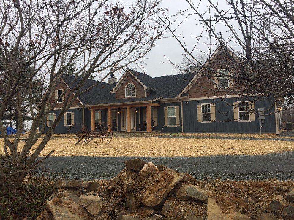 Large and blue traditional two floor detached house in DC Metro with wood cladding, a hip roof and a shingle roof.