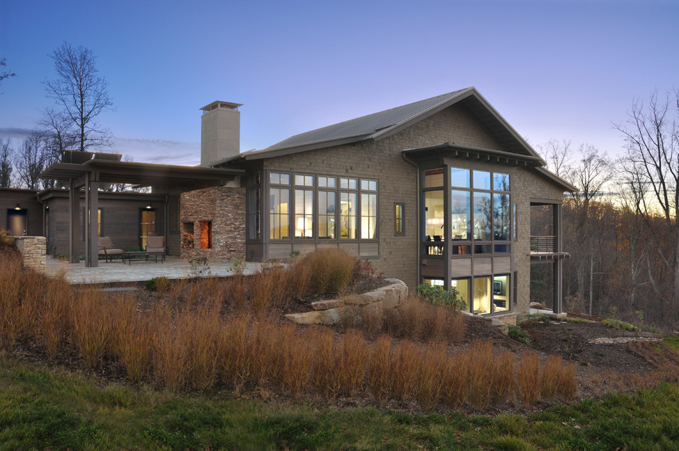 Diseño de fachada de casa marrón moderna de tamaño medio de dos plantas con revestimiento de madera, tejado a dos aguas y tejado de metal