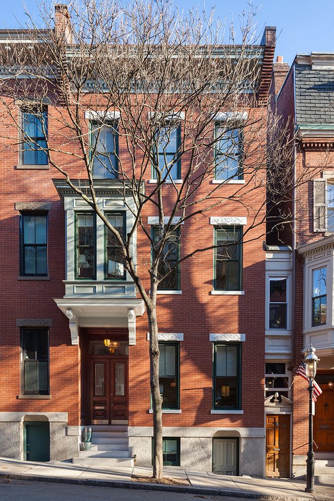 Design ideas for a classic brick house exterior in Boston with three floors and a flat roof.