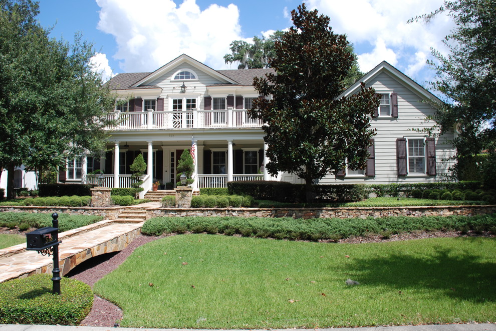 Example of a large classic beige two-story wood gable roof design in Orlando