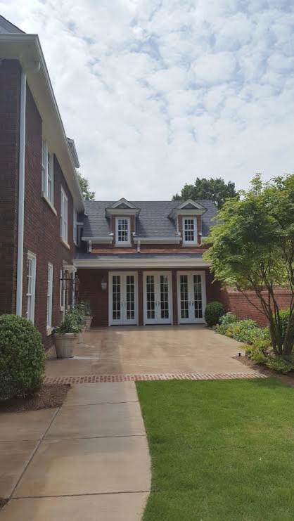 Large elegant red three-story brick exterior home photo in Birmingham with a shingle roof