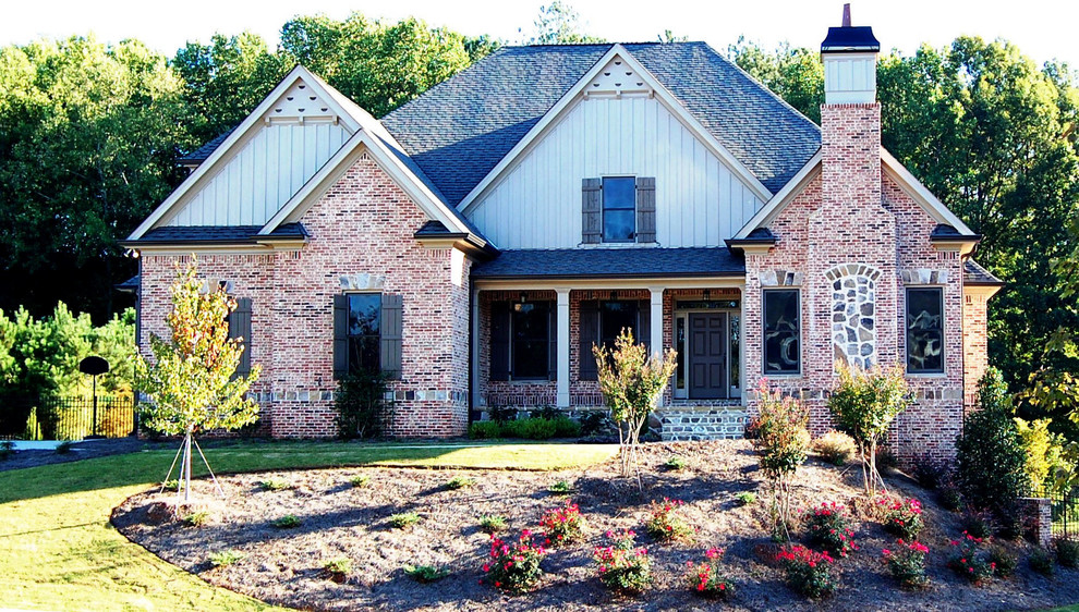 Medium sized and beige classic two floor brick house exterior in Atlanta with a half-hip roof.