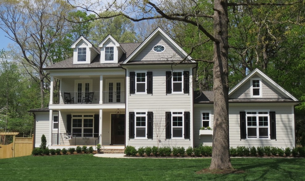 Large traditional beige two-story exterior home idea in Raleigh