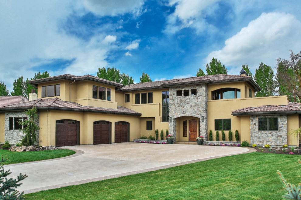 This is an example of a beige mediterranean two floor render house exterior in Boise.