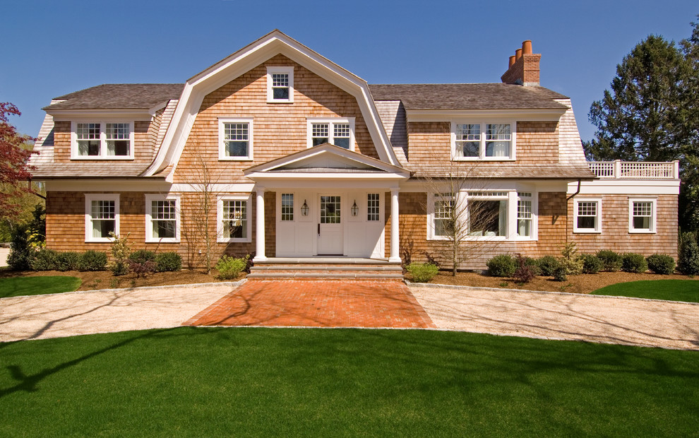 Elegant two-story wood exterior home photo in New York with a gambrel roof