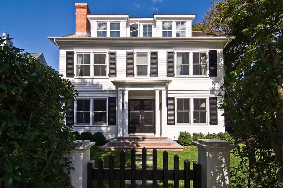 Photo of a white classic house exterior in New York with three floors.