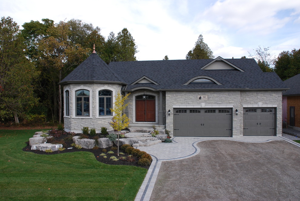 Aménagement d'une façade de maison grise classique en pierre de taille moyenne et de plain-pied avec un toit à deux pans.