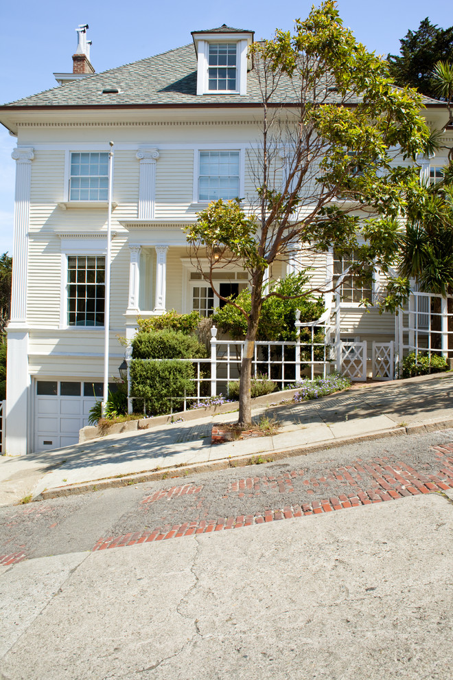 Example of a classic yellow two-story exterior home design in Other