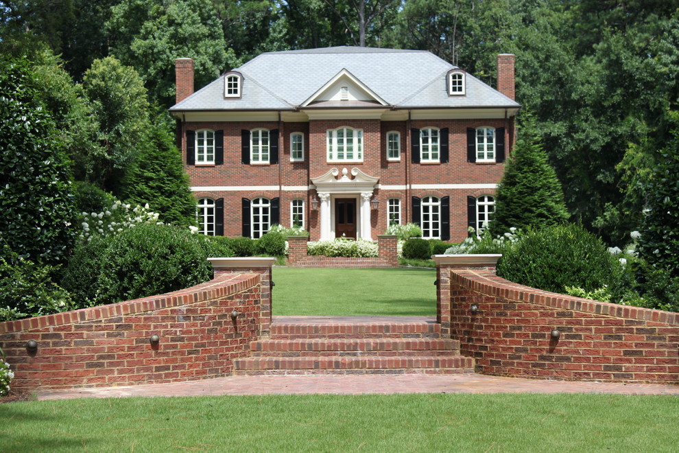 Elegant red two-story brick exterior home photo in Atlanta