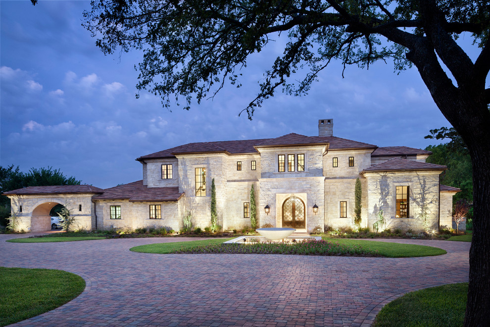 Large elegant stone exterior home photo in Austin