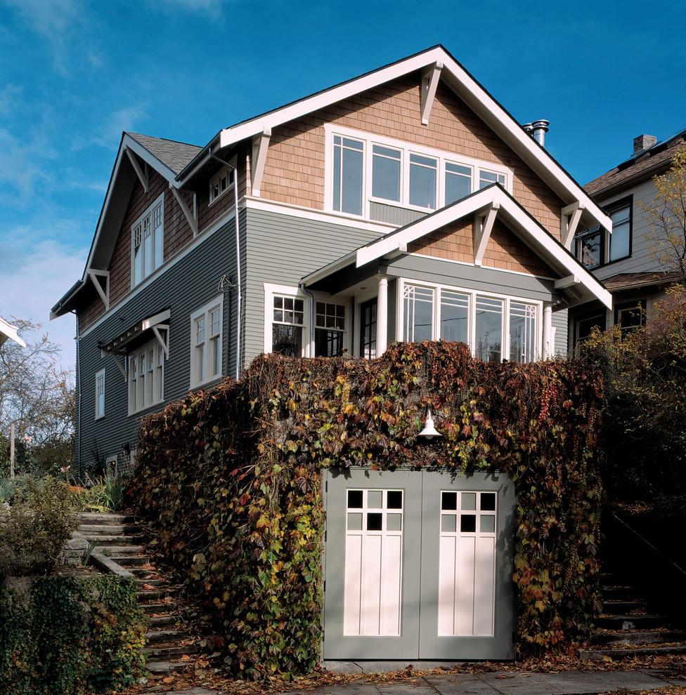 Design ideas for a traditional house exterior in Seattle with wood cladding and a pitched roof.
