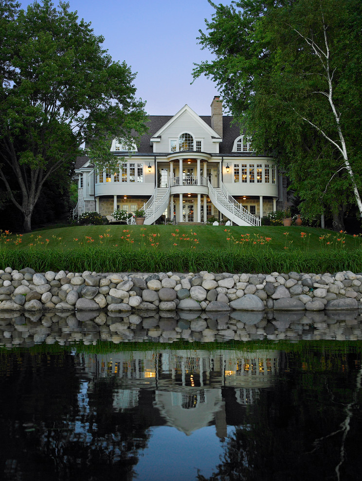 Inspiration for a traditional house exterior in Milwaukee with three floors.