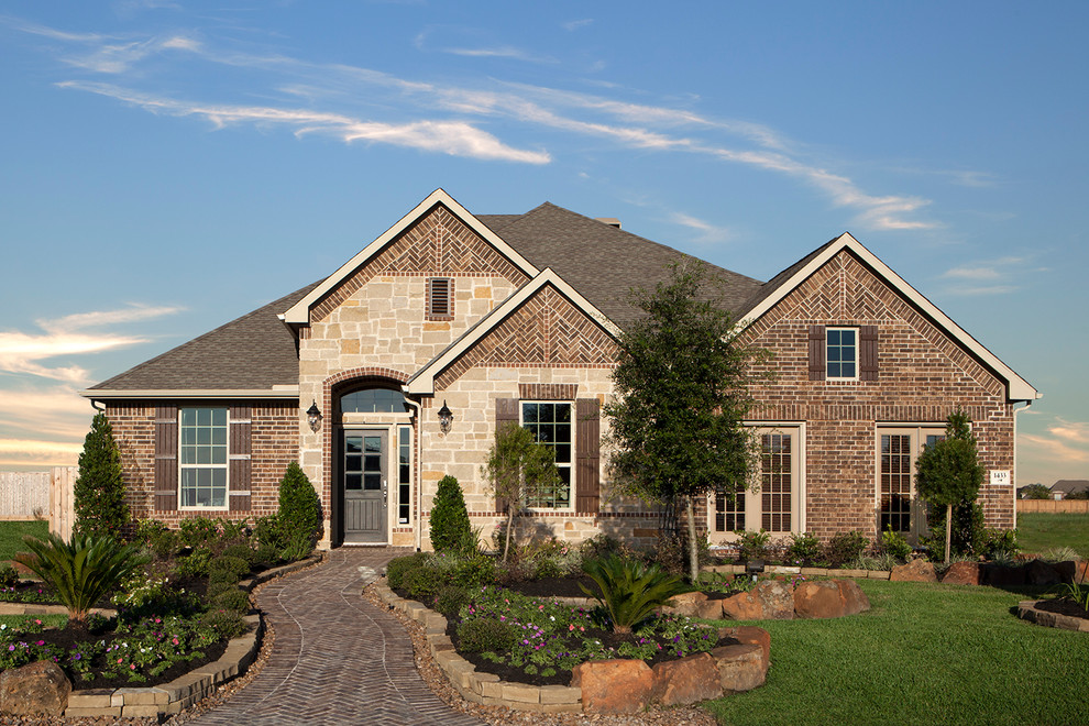 Photo of a traditional brick house exterior in Houston with a pitched roof.