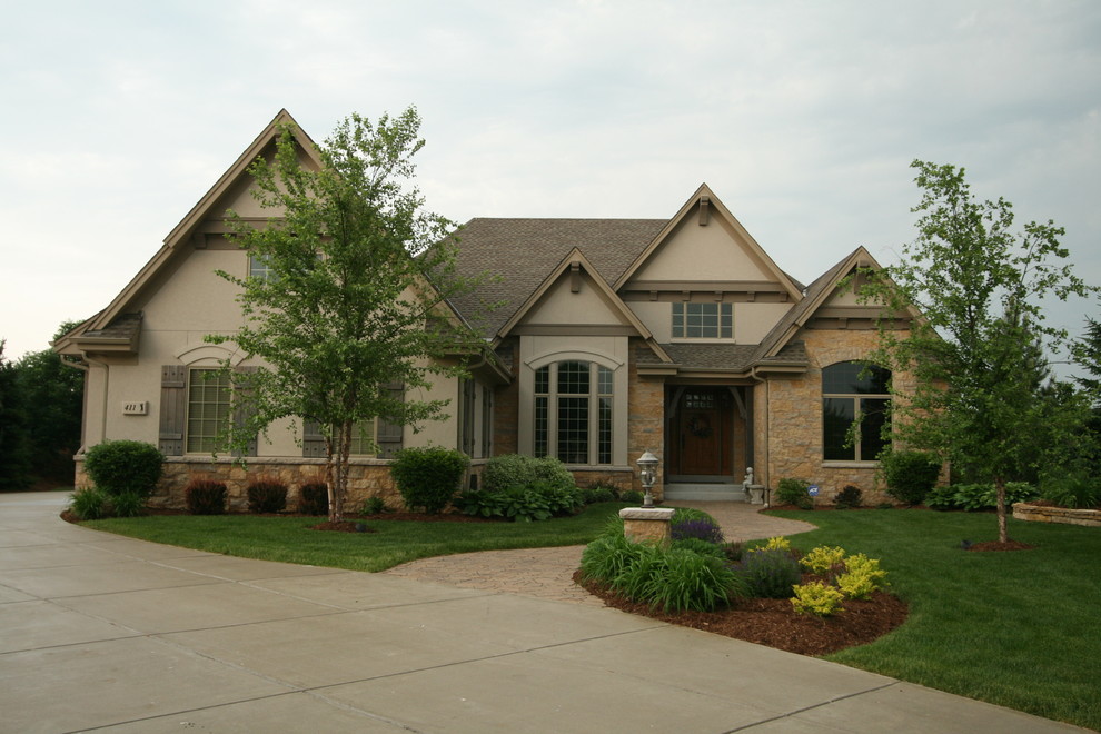 Photo of a traditional house exterior in Milwaukee with stone cladding.