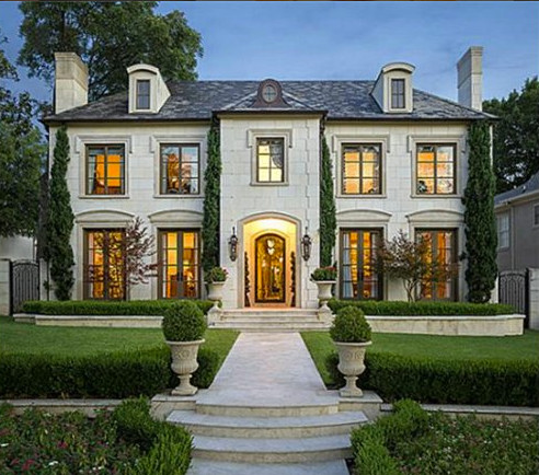 Example of a large classic white two-story stone exterior home design in Dallas with a hip roof