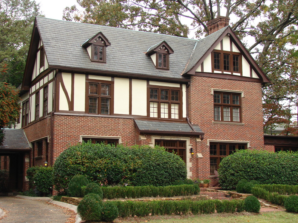 Design ideas for a classic brick house exterior in Atlanta with three floors and a pitched roof.