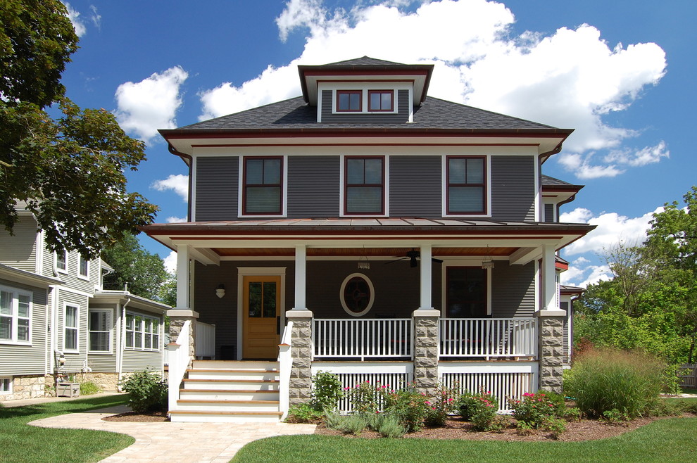 Example of a classic two-story exterior home design in Chicago with a hip roof and a mixed material roof
