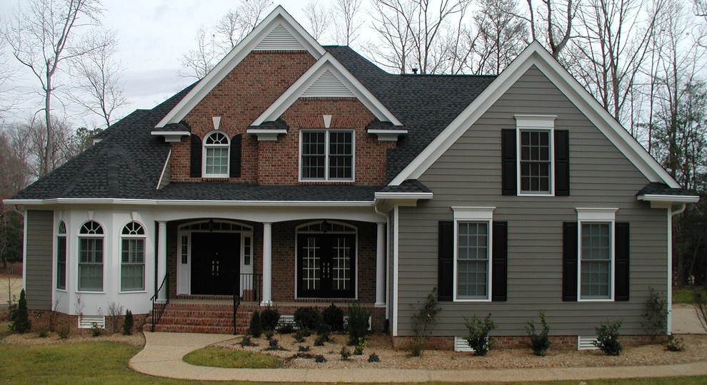 Example of a mid-sized classic multicolored two-story mixed siding exterior home design in Other with a shingle roof