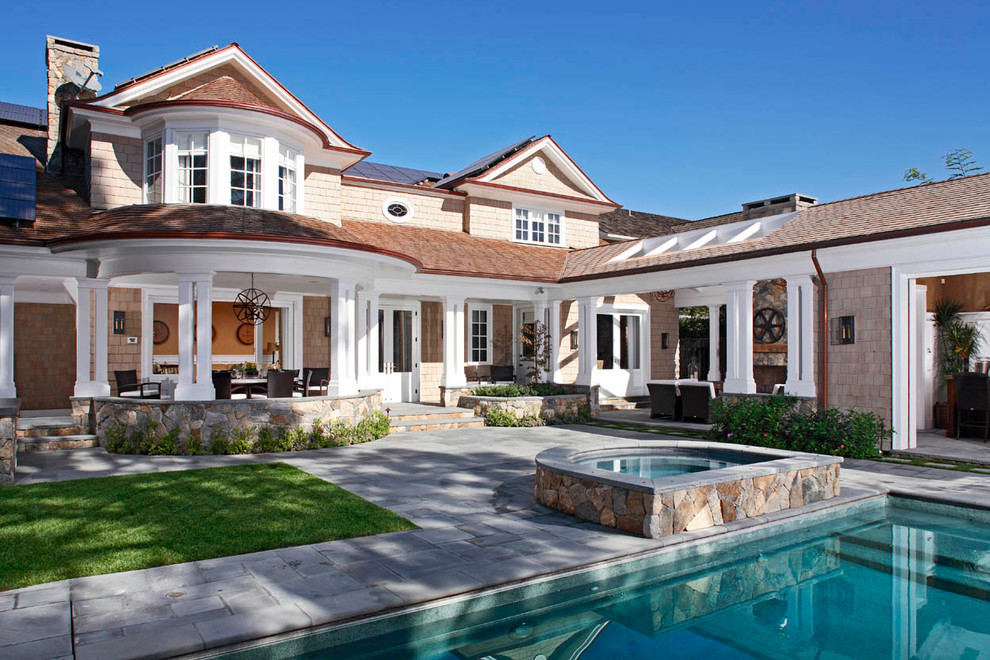 Inspiration for a large coastal beige two-story wood exterior home remodel in Orange County