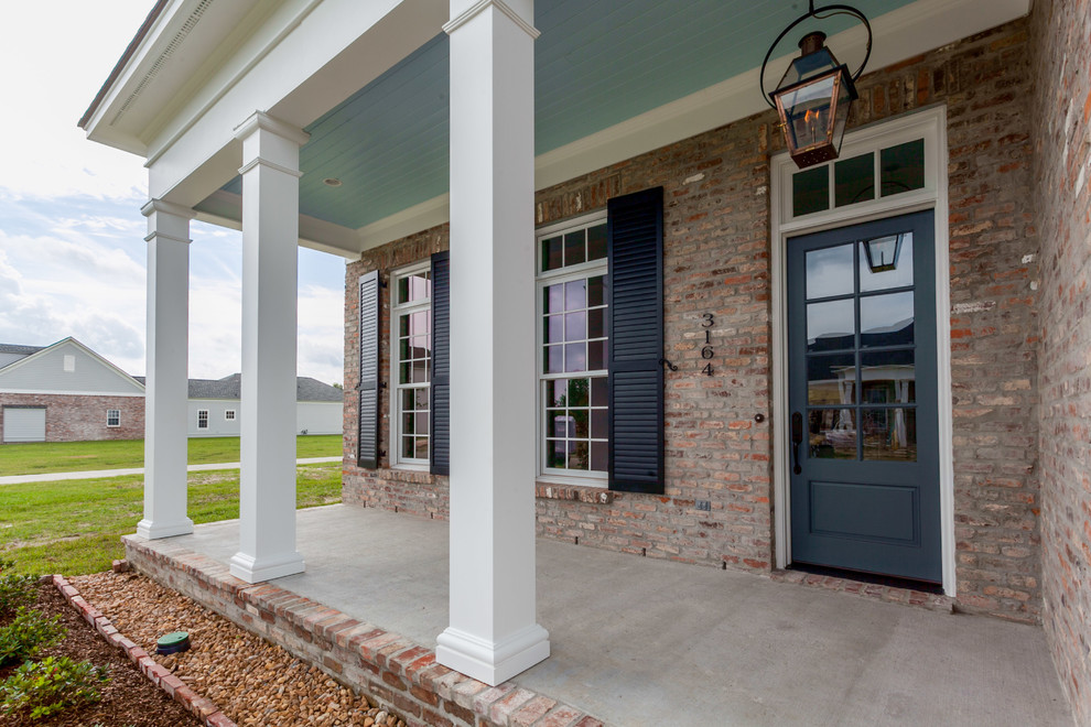 Inspiration for a mid-sized timeless one-story mixed siding gable roof remodel in New Orleans