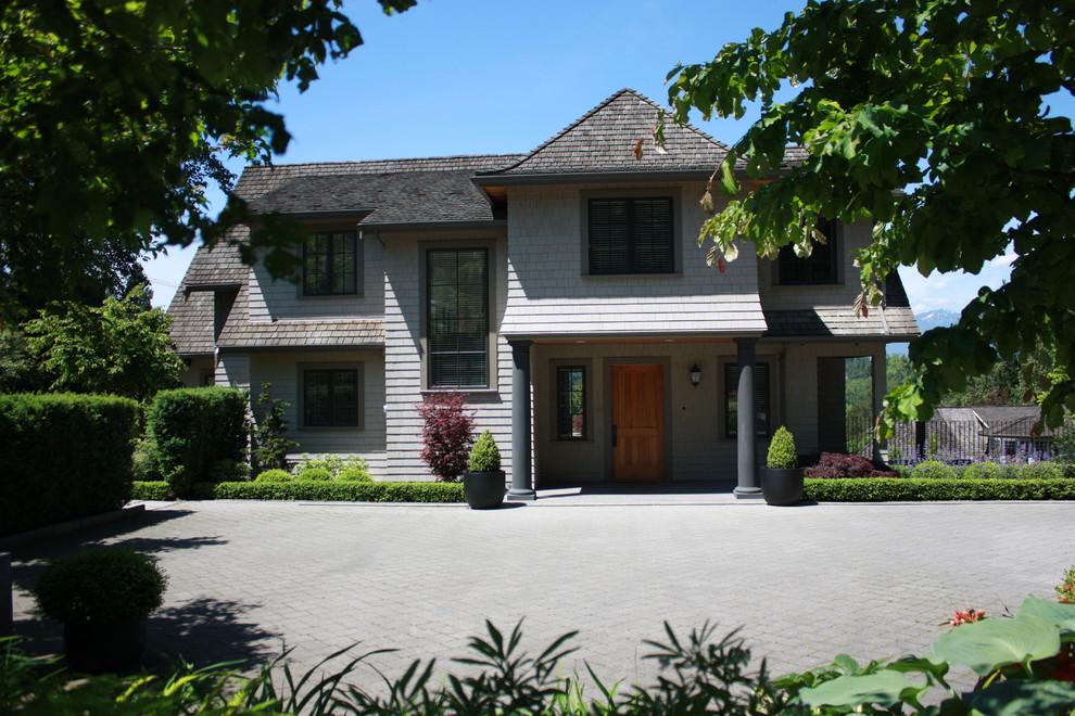 Large traditional gray two-story wood exterior home idea in Vancouver