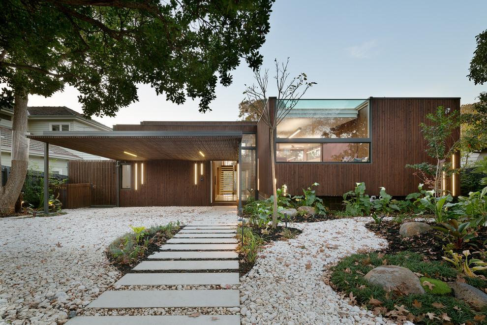 Photo of a brown contemporary bungalow detached house in Melbourne with wood cladding and a flat roof.