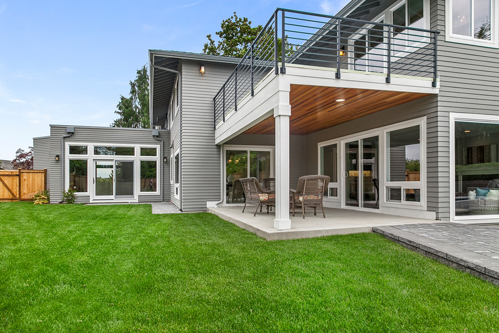 Inspiration for a large transitional gray two-story vinyl exterior home remodel in Seattle