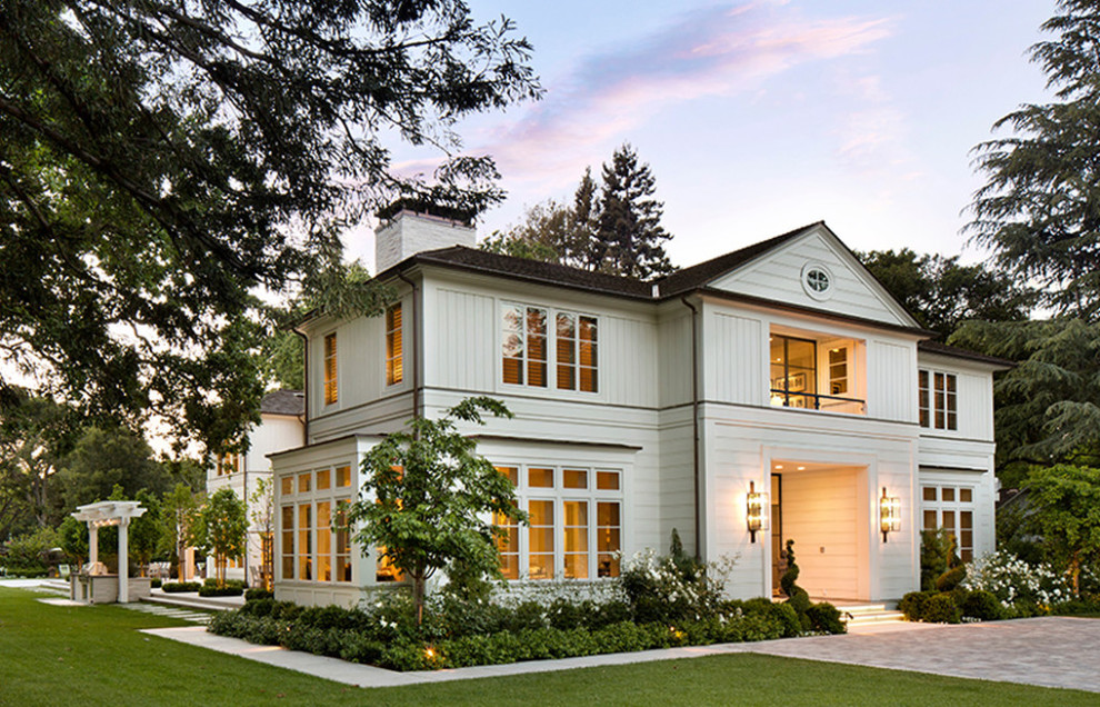 Mid-sized elegant white two-story wood house exterior photo in Miami with a hip roof and a shingle roof