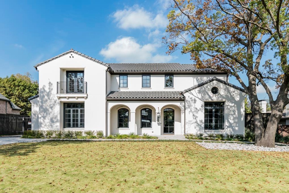 Large transitional white two-story stucco house exterior idea in Dallas with a tile roof
