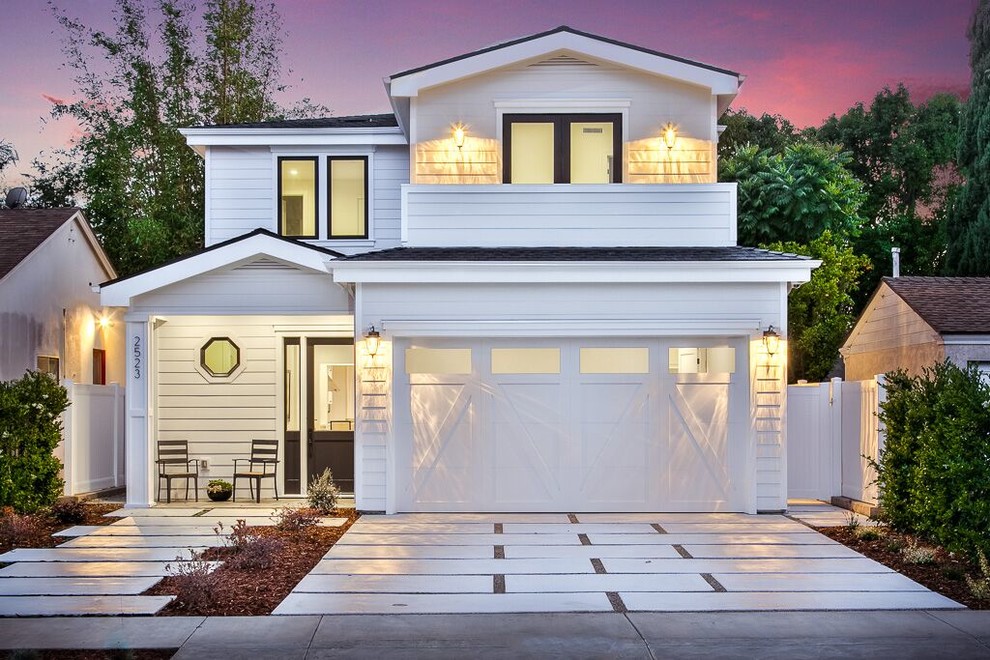Mid-sized transitional white two-story wood house exterior idea in Orange County with a hip roof and a shingle roof