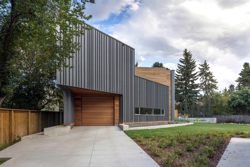 Design ideas for a contemporary house exterior in Edmonton with metal cladding.