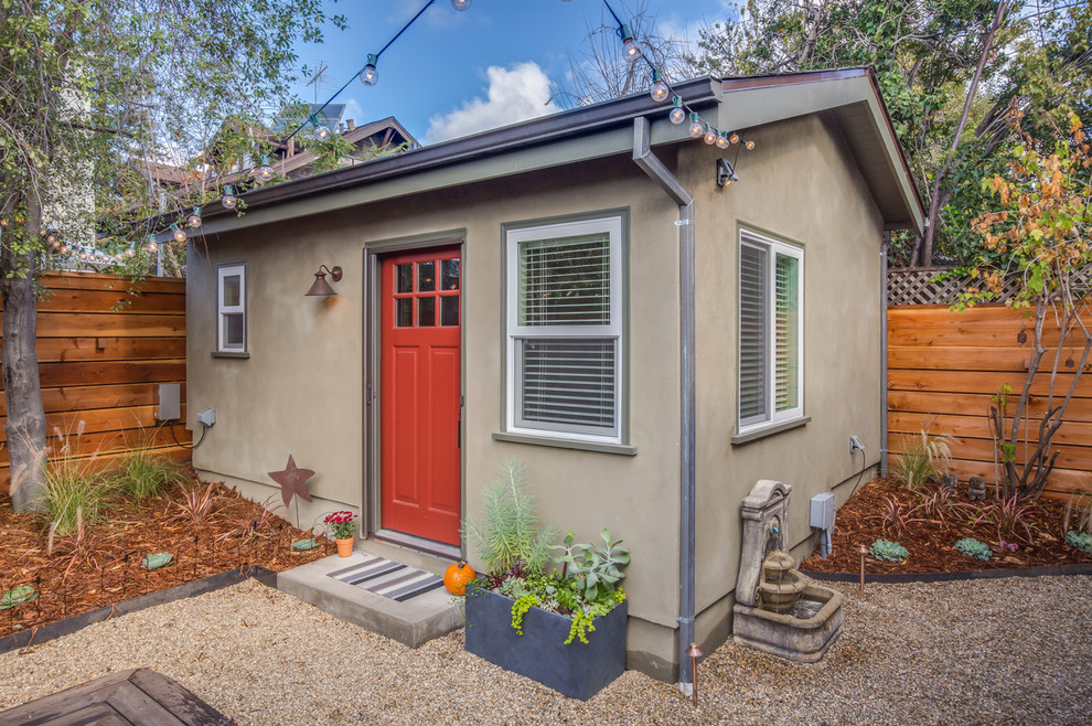 Photo of a small and beige classic bungalow render house exterior in San Francisco with a pitched roof.